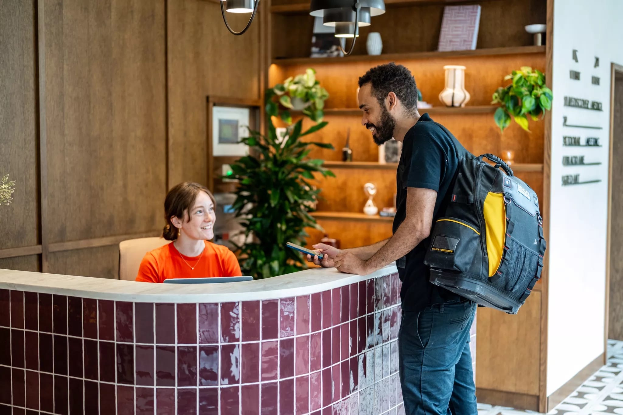A Reeve operative checking in with a receptionist at an office front desk